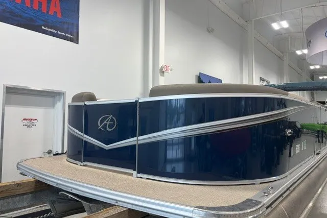 Slide: The Image of 2022 Avalon LSZ 2285 CR pontoon boat in showroom, featuring sleek blue exterior design. - 4