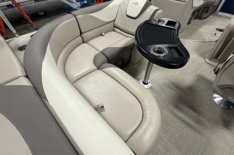Slide: The Image of Luxurious seating area in 2022 Avalon LSZ 2285 CR pontoon boat with table and cup holders. - 10