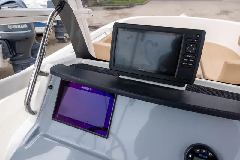 Slide: The Image of The image shows the cockpit of a 2022 Bayliner T22CX with modern navigation equipment. - 9