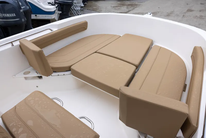 Slide: The Image of The image shows the seating area of a 2022 Bayliner T22CX boat with beige cushions. - 11