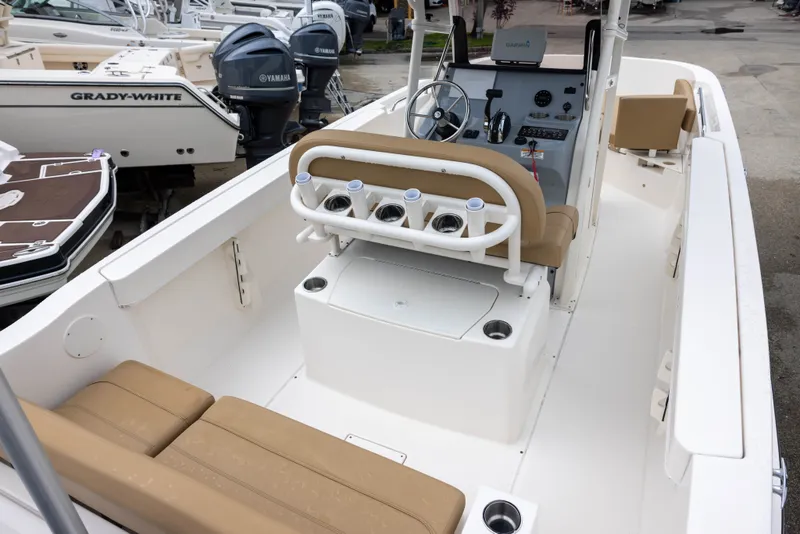 Slide: The Image of The image shows a 2022 Bayliner T22CX boat with beige seating and a helm console. - 5
