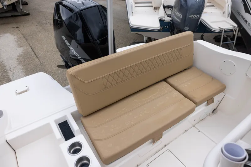 Slide: The Image of The image shows a beige bench seat on a 2022 Bayliner T22CX boat. - 6