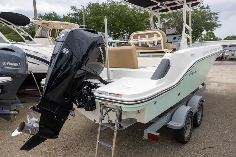 Slide: The Image of A 2022 Bayliner T22CX on a trailer, featuring a powerful outboard motor. - 3