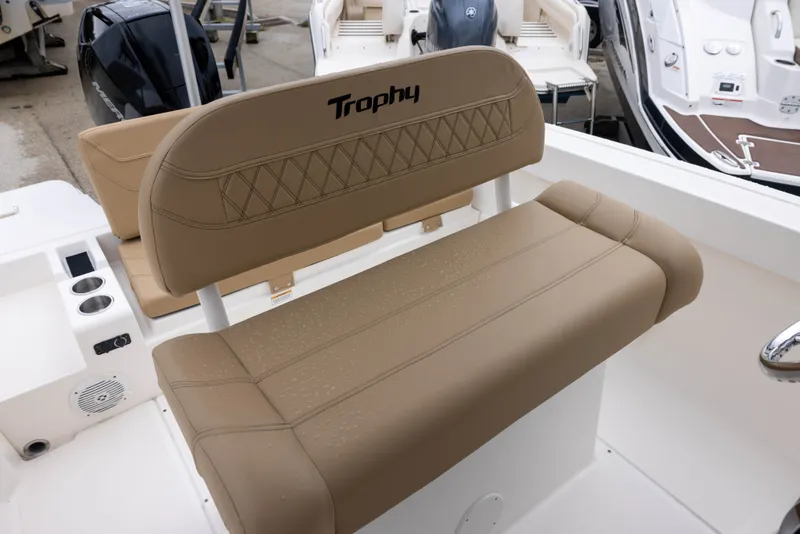Slide: The Image of The image shows the beige upholstery of a Bayliner T22CX boat's rear bench from 2022. - 8