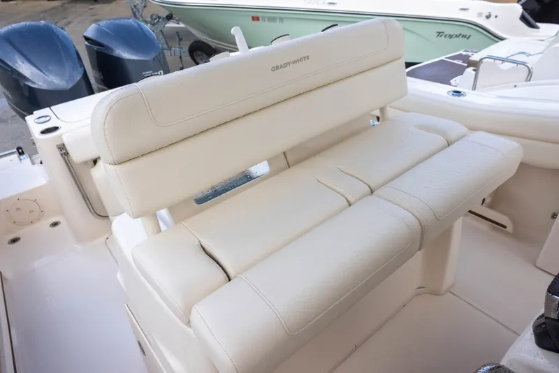Slide: The Image of The 2021 Grady-White Canyon 271 features a cushioned bench seat in the cockpit area. - 12