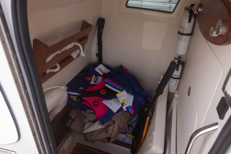 Slide: The Image of Interior of a boat with life jackets and fire extinguishers neatly stored. - 18