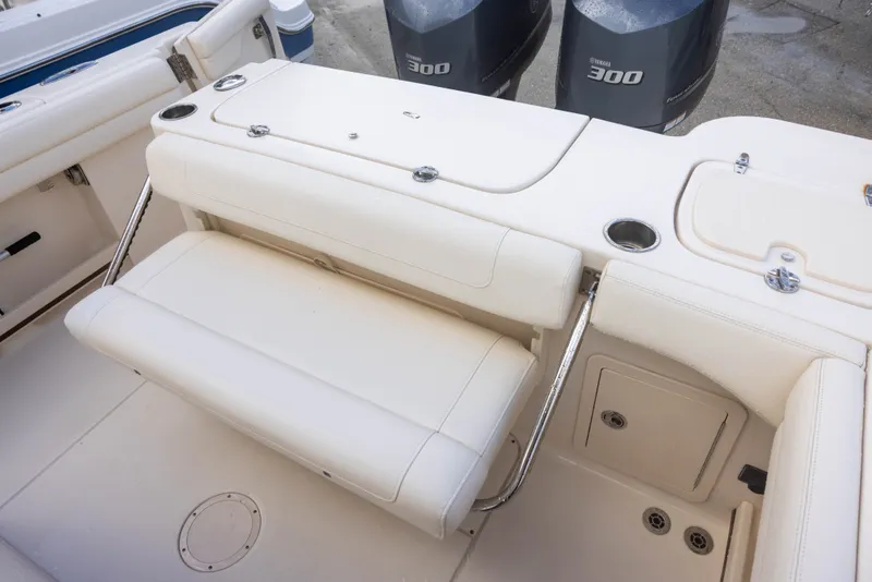 Slide: The Image of The image shows the cockpit of a Grady-White Canyon 271 with beige upholstery and two outboard engines. - 8