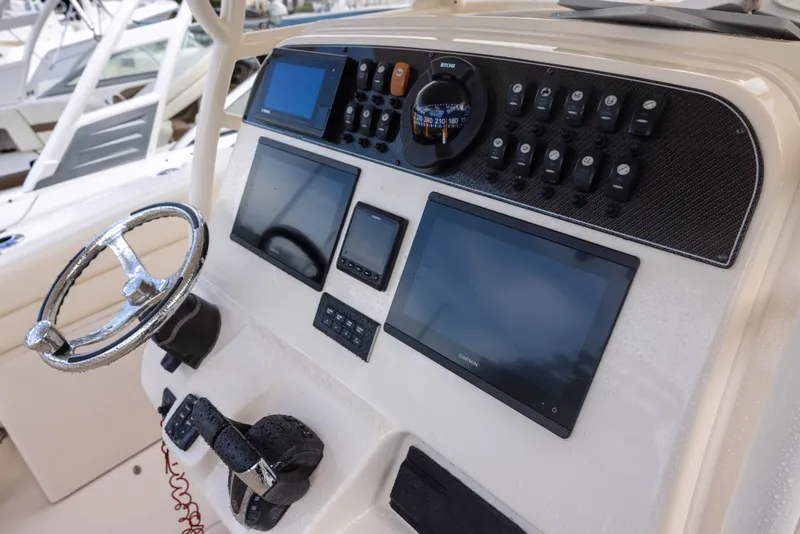 Slide: The Image of The image shows the cockpit of a Grady-White Canyon 271 boat with modern navigation equipment. - 11