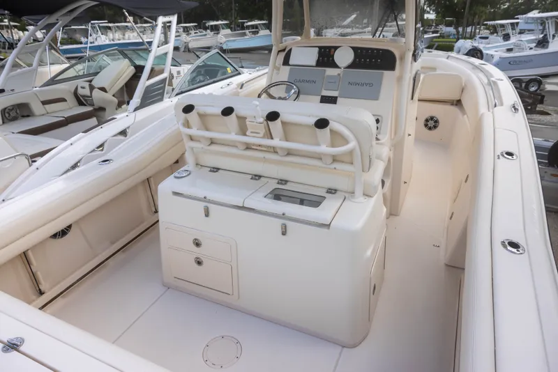 Slide: The Image of The image shows the cockpit of a 2021 Grady-White Canyon 271 with a helm console and seating. - 5