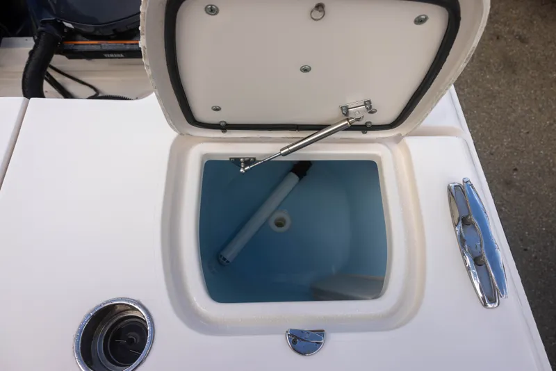 Slide: The Image of An open storage compartment on a Grady-White Canyon 271 boat, featuring a blue interior. - 9
