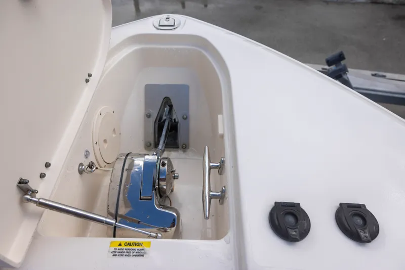 Slide: The Image of The anchor locker of a 2021 Grady-White Canyon 271 with stainless steel fittings and windlass. - 15
