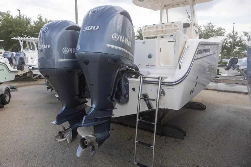 Slide: The Image of Two Yamaha outboard engines on a Grady-White Canyon 271 boat, with a ladder at the stern. - 4