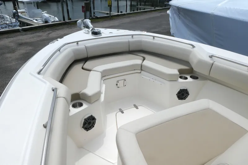 Slide: The Image of 2027 Boston Whaler 250 Outrage boat interior with cushioned seating and cup holders. - 11