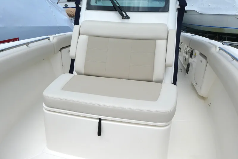 Slide: The Image of 2027 Boston Whaler 250 Outrage boat interior with cushioned seating. - 13