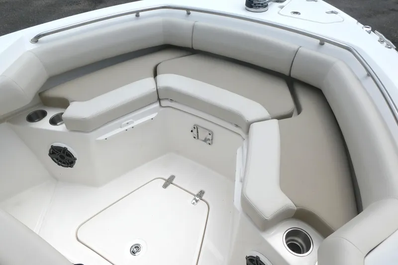 Slide: The Image of 2027 Boston Whaler 250 Outrage boat interior with cushioned seating and cup holders. - 14