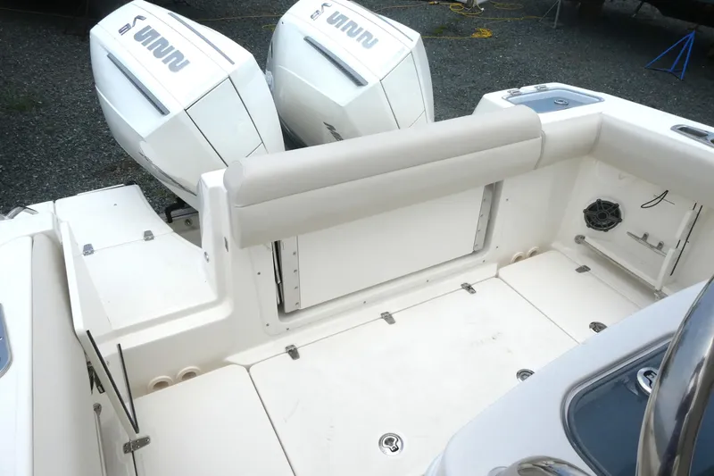 Slide: The Image of 2027 Boston Whaler 250 Outrage boat interior with dual engines and seating area. - 6