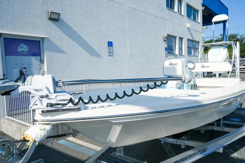 Slide: The Image of 2027 Maverick Mirage 18 HPX-V boat on trailer outside a building. - 3