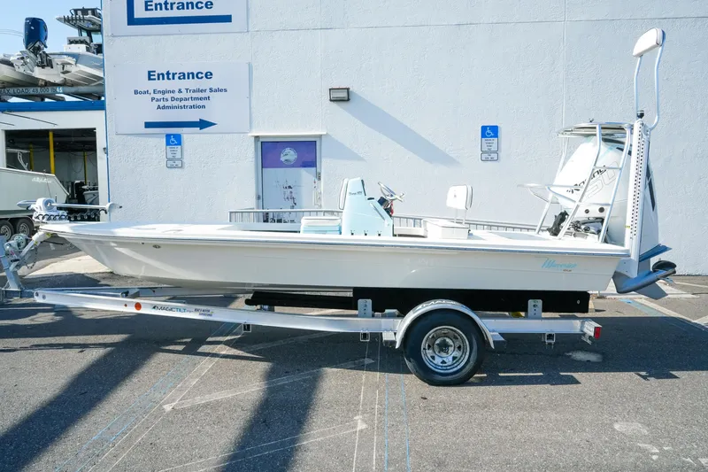 The Image of 2027 Maverick Mirage 18 HPX-V boat on trailer, parked outside dealership entrance. - 1