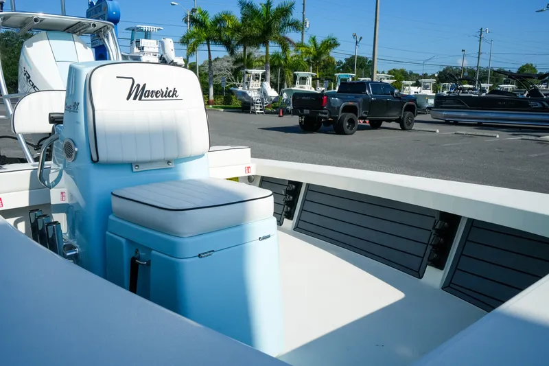 Slide: The Image of 2027 Maverick Mirage 18 HPX-V boat interior with seating, parked in a marina. - 24