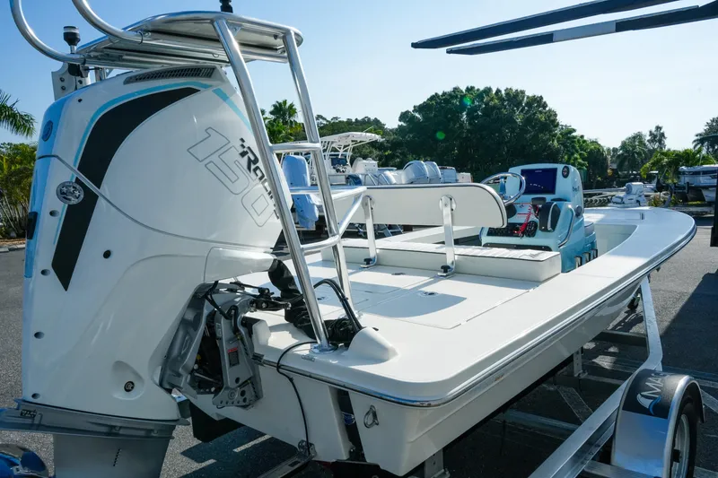 Slide: The Image of 2027 Maverick Mirage 18 HPX-V boat with powerful 150 HP engine, parked outdoors. - 7