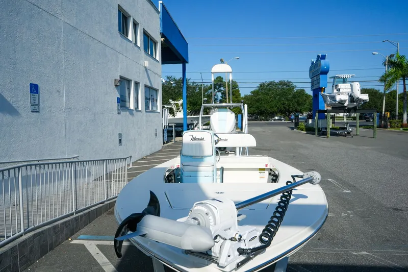 Slide: The Image of 2027 Maverick Mirage 18 HPX-V boat parked outside a building on a sunny day. - 5