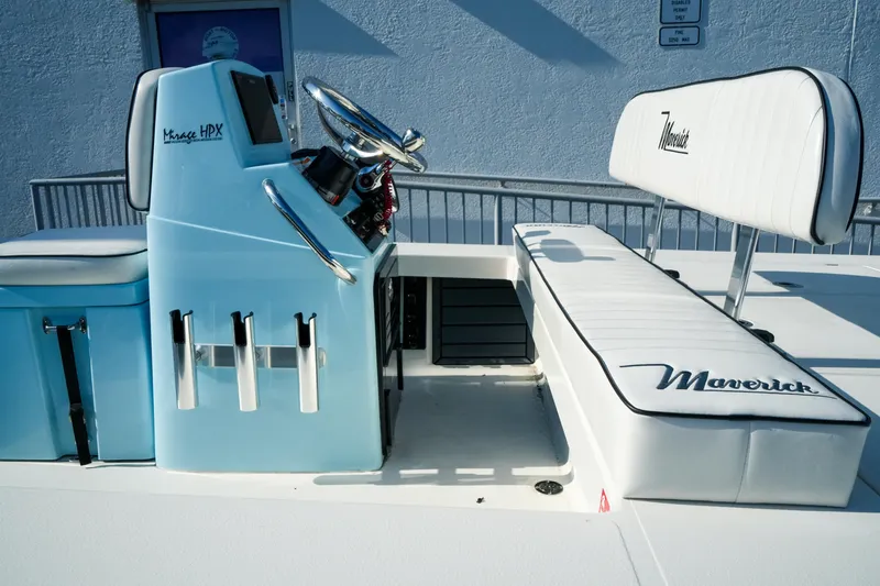 Slide: The Image of 2027 Maverick Mirage 18 HPX-V boat interior with sleek blue console and white seating. - 16