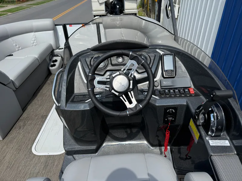 Slide: The Image of The image shows the cockpit of a 2022 Crest Classic Platinum 220 SLC with a modern helm. - 9