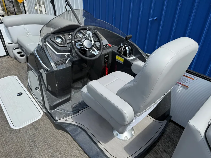 Slide: The Image of The image shows the helm of a 2022 Crest Classic Platinum 220 SLC boat with a gray seat. - 8