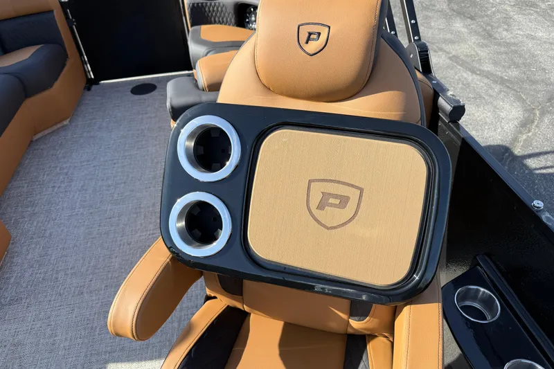 Slide: The Image of Luxurious interior of 2026 Premier 230 SunSation RF with tan seating and cup holders. - 23