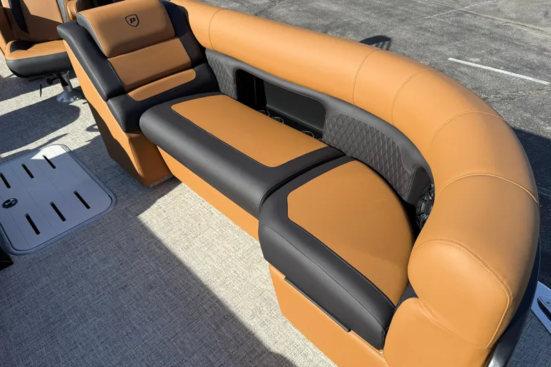 Slide: The Image of Luxurious seating on the 2026 Premier 230 SunSation RF pontoon boat, featuring tan and black upholstery. - 6