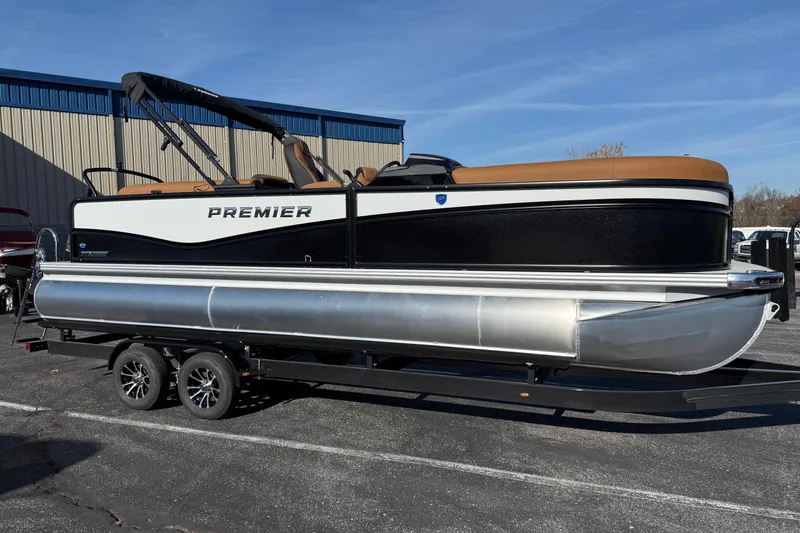 Slide: The Image of 2026 Premier 230 SunSation RF pontoon boat on trailer, parked outdoors. - 3