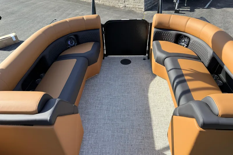 Slide: The Image of 2026 Premier 230 SunSation RF boat interior with tan and black seating, carpeted floor. - 25