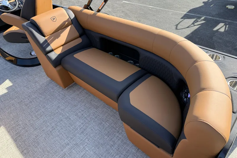 Slide: The Image of Luxurious seating on 2026 Premier 230 SunSation RF boat, featuring tan and black upholstery. - 27