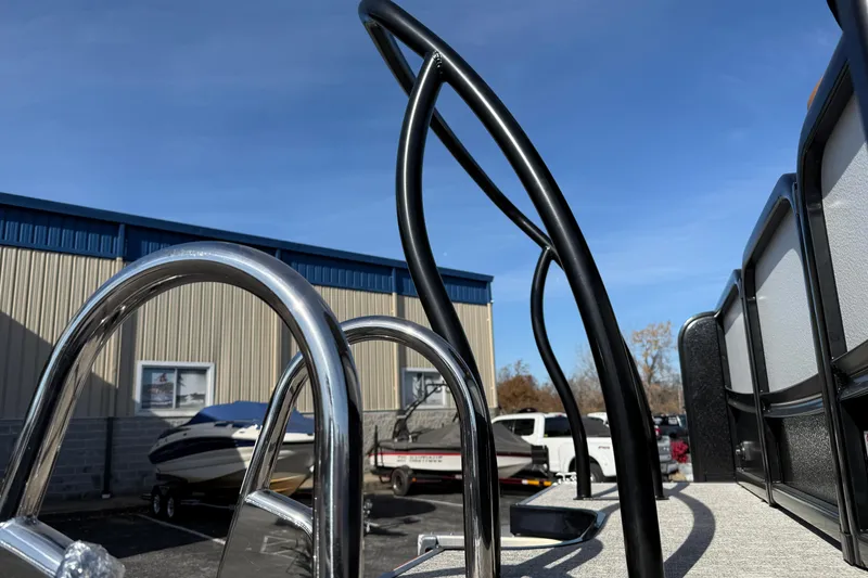 Slide: The Image of 2026 Premier 230 SunSation RF boat with sleek metal railings, outdoor setting. - 37