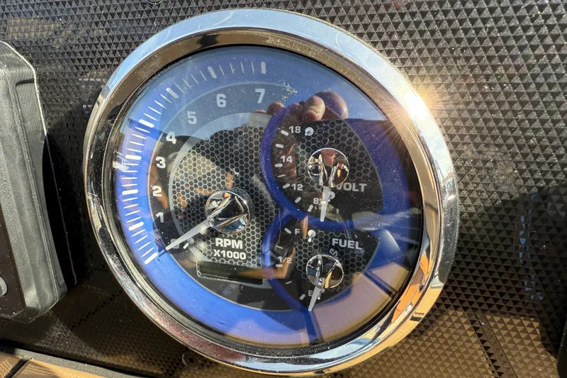 Slide: The Image of Close-up of 2026 Premier 230 SunSation RF dashboard gauges reflecting sunlight. - 15