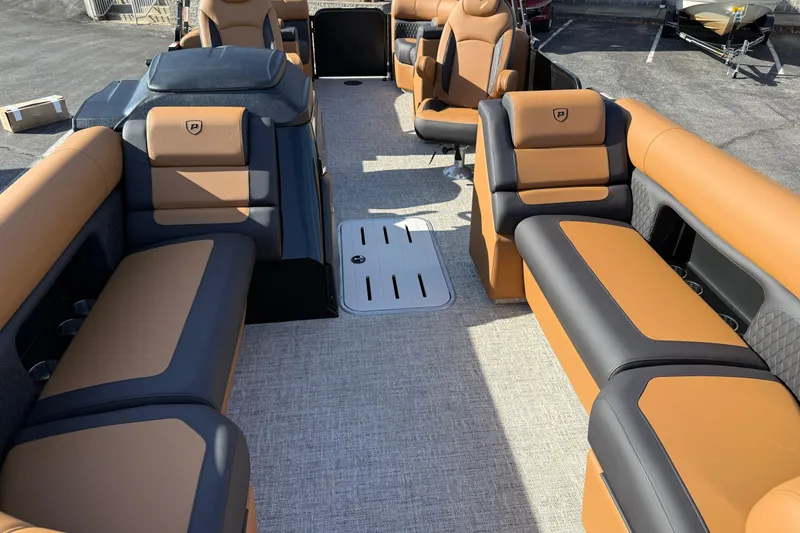 Slide: The Image of Luxurious interior of 2026 Premier 230 SunSation RF pontoon boat with tan and black seating. - 5
