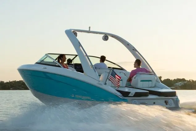 Slide: The Image of Manufacturer Provided Image: 2026 Regal LS4 boat cruising on a calm lake at sunset. - 12