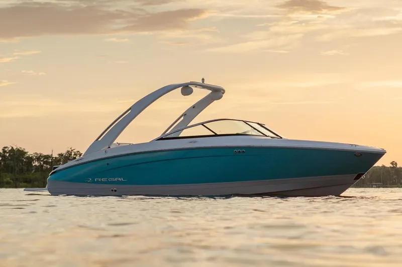 Slide: The Image of Manufacturer Provided Image: 2026 Regal LS4 boat on water at sunset, showcasing sleek design and modern features. - 14