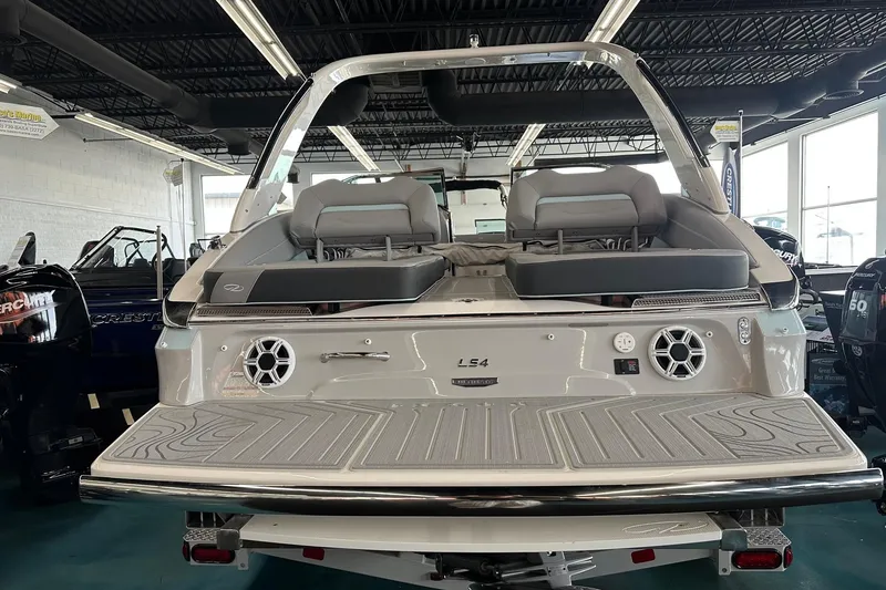Slide: The Image of 2026 Regal LS4 boat interior with cushioned seating and modern design in showroom. - 8