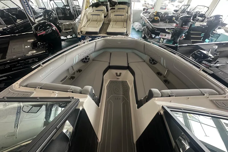 Slide: The Image of 2026 Regal LS4 boat interior with spacious seating and modern design in showroom. - 6
