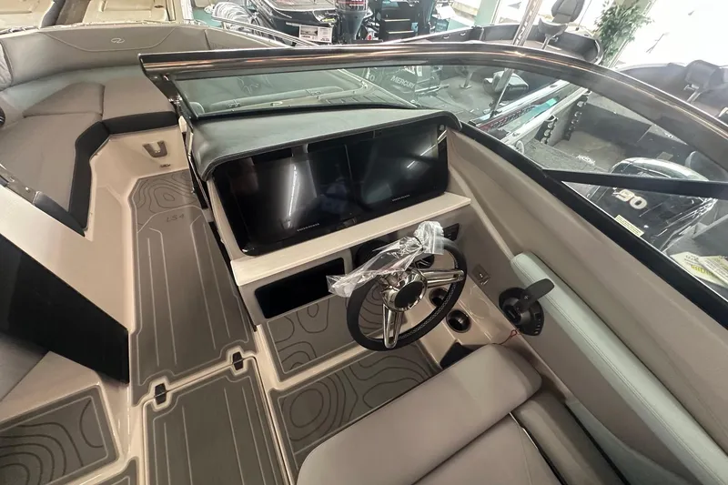 Slide: The Image of Interior view of a 2026 Regal LS4 boat cockpit with modern steering and dashboard. - 4