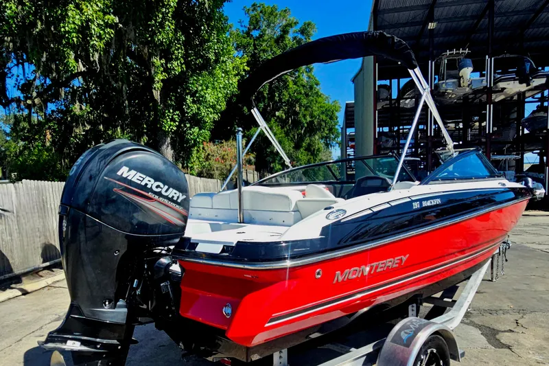 Slide: The Image of 2015 Monterey 197 Blackfin boat with Mercury engine on trailer, parked outdoors. - 3