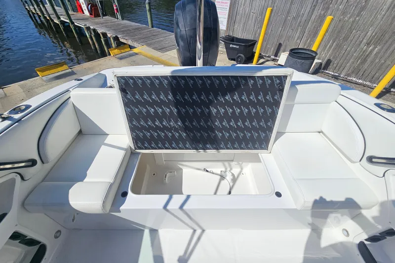 Slide: The Image of 2015 Monterey 197 Blackfin boat interior with open storage compartment, dockside view. - 20
