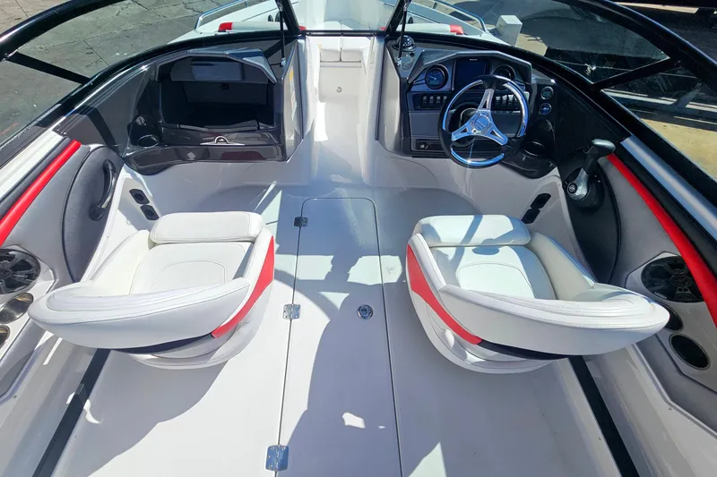 Slide: The Image of Interior of a 2015 Monterey 197 Blackfin boat with dual white seats and steering console. - 9