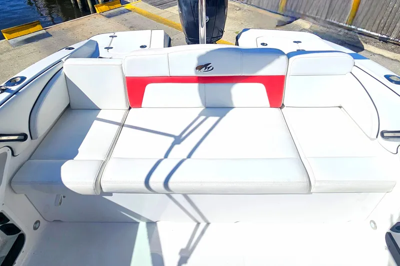 Slide: The Image of 2015 Monterey 197 Blackfin boat with white and red seating at a dock. - 6