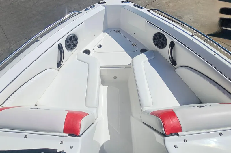 Slide: The Image of 2015 Monterey 197 Blackfin boat interior with white and red seating, speakers, and stainless steel accents. - 24