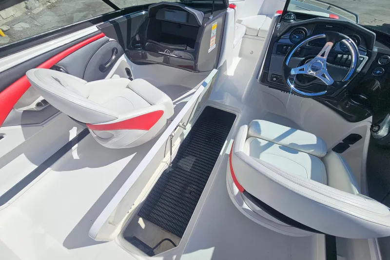 Slide: The Image of 2015 Monterey 197 Blackfin boat interior with white and red seating, steering wheel, and storage. - 19