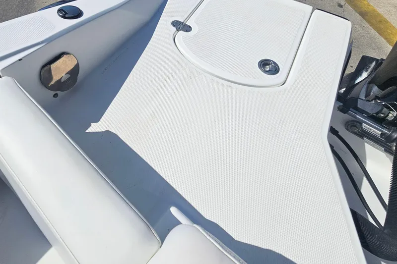 Slide: The Image of 2015 Monterey 197 Blackfin boat deck, featuring white textured surface and storage hatch. - 8