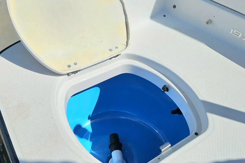 Slide: The Image of Open hatch on 2015 Monterey 197 Blackfin boat, revealing blue interior compartment. - 26