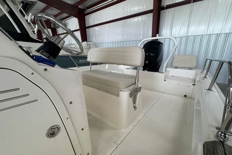 Slide: The Image of 2022 Boston Whaler 190 Montauk boat interior with steering wheel and seating. - 29